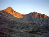 The first rays of the sun hit McHenrys Peak and The Arrowhead....